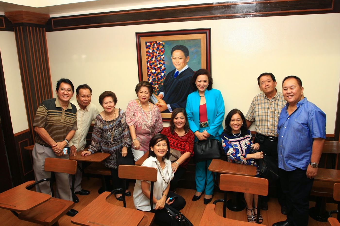 Family and friends gathered beneath his portrait
