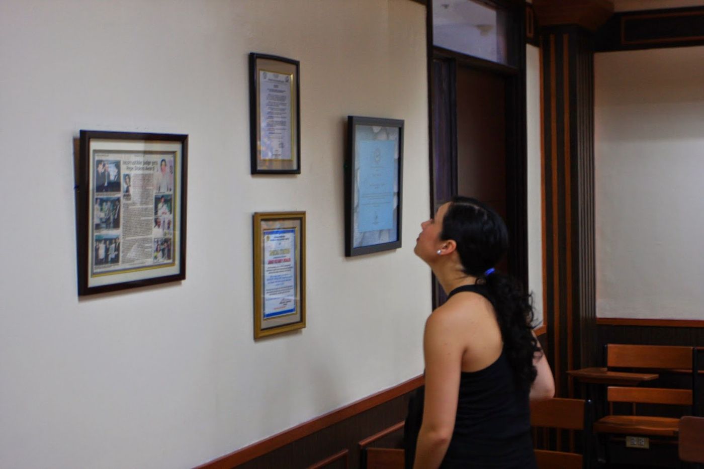 Framed clippings and citations on the wall of the Rosales Room