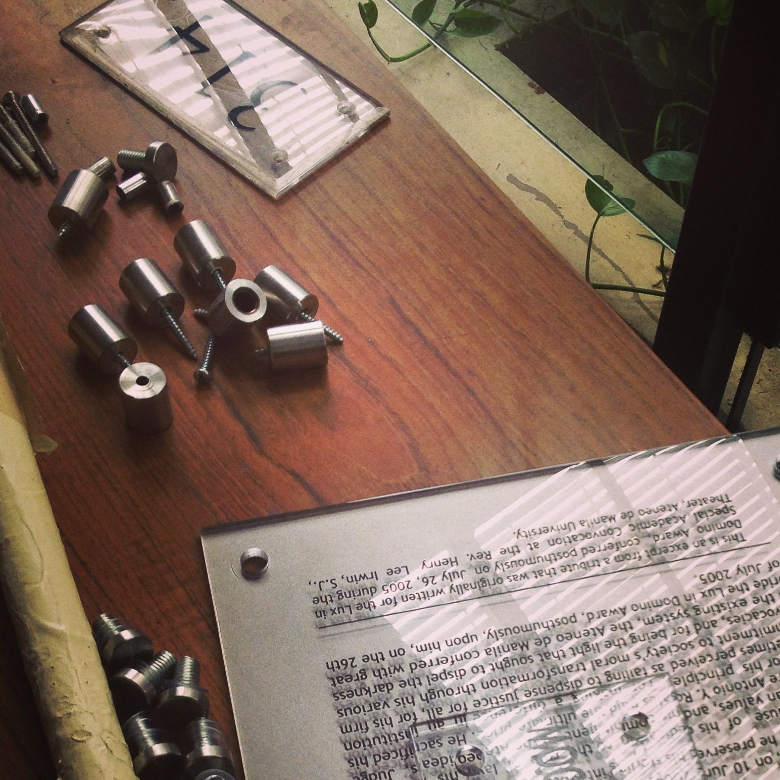 The tribute plaque and its fittings laid out before mounting